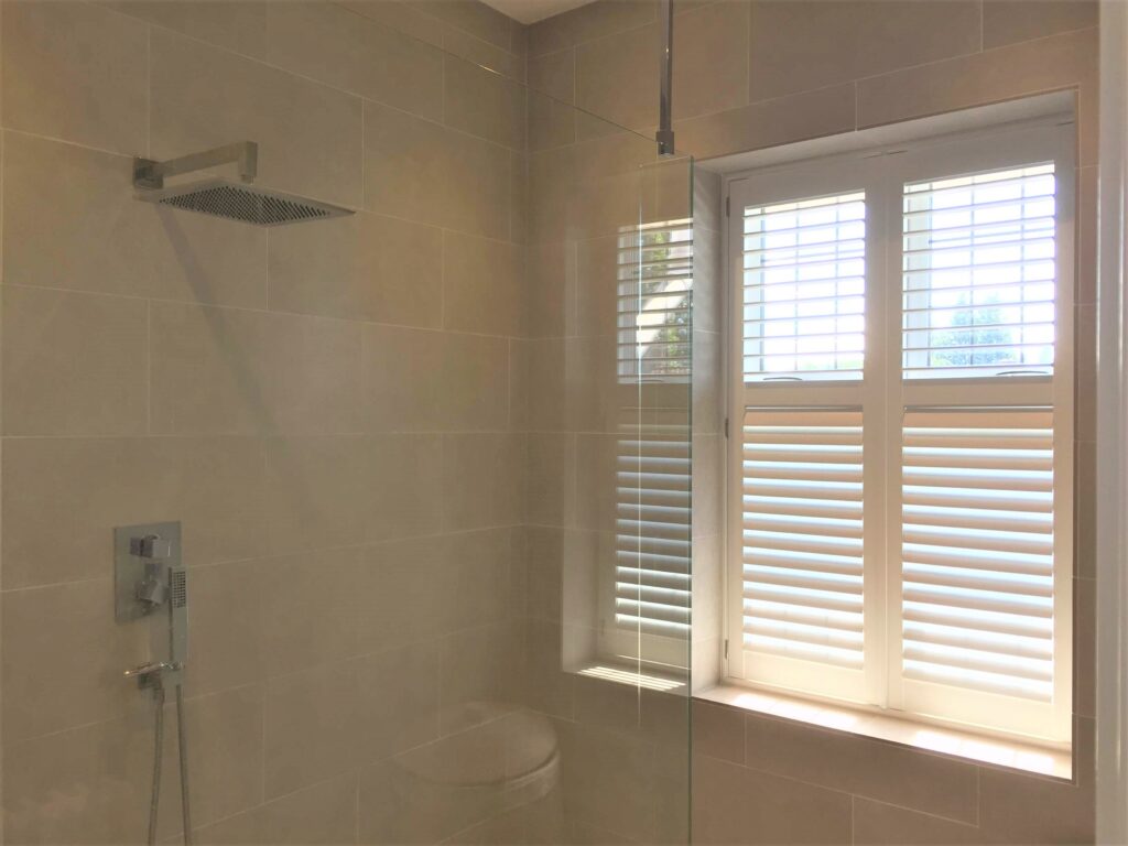 Modern shower room with white shutter half open
