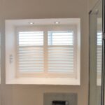 Modern shower room with white shutter