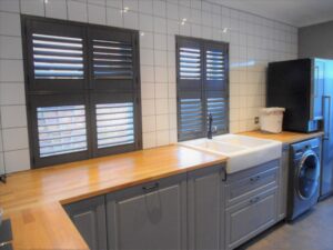 Black kitchen shutters with a grey kitchen