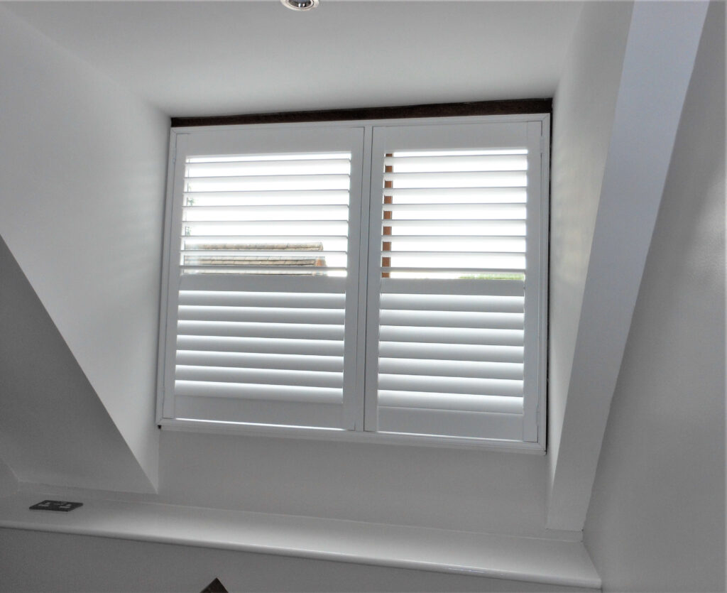 Attic room with white window shutter