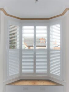 Large 4-panel white bay window shutter