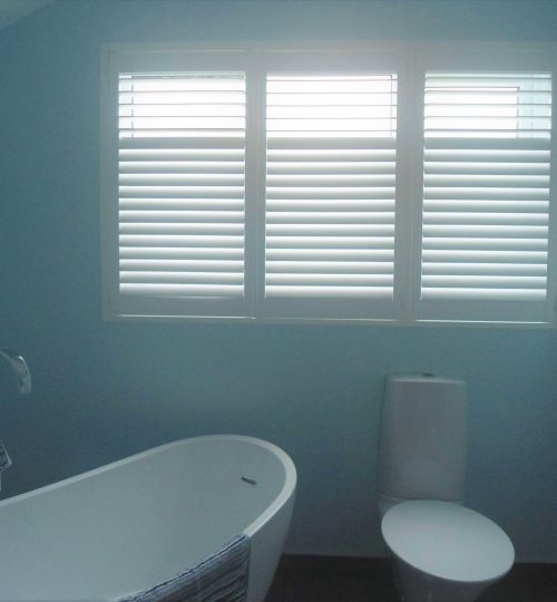 Blue bathroom with white shutter