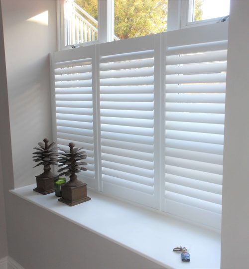white cafe shutters on white wall