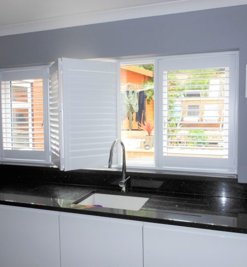 Half open white kitchen shutters