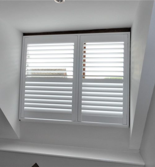 Attic room with white window shutter