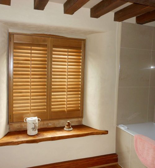 Traditional oak shutters in a bathroom