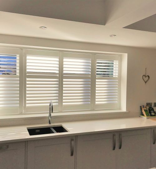 Ambient kitchen with half open white shutters