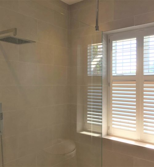 Modern shower room with white shutter half open