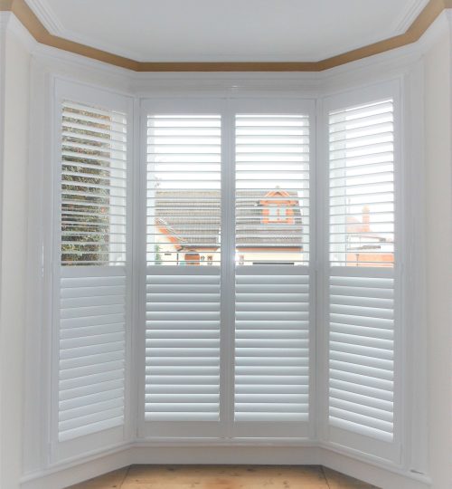 Large 4-panel white bay window shutter