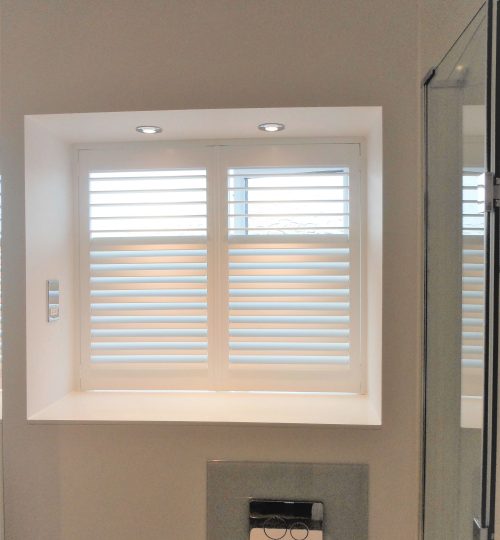 Modern shower room with white shutter