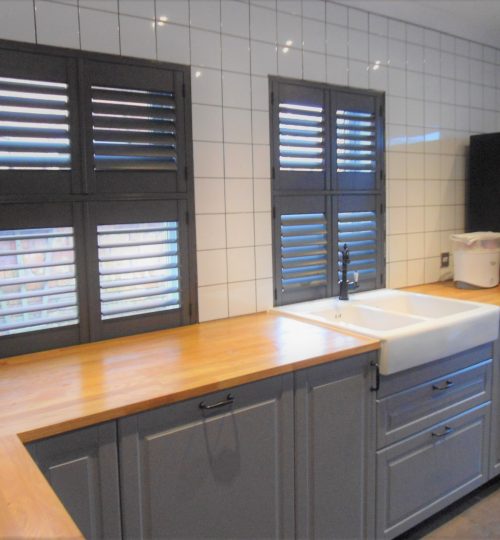 Black kitchen shutters with a grey kitchen